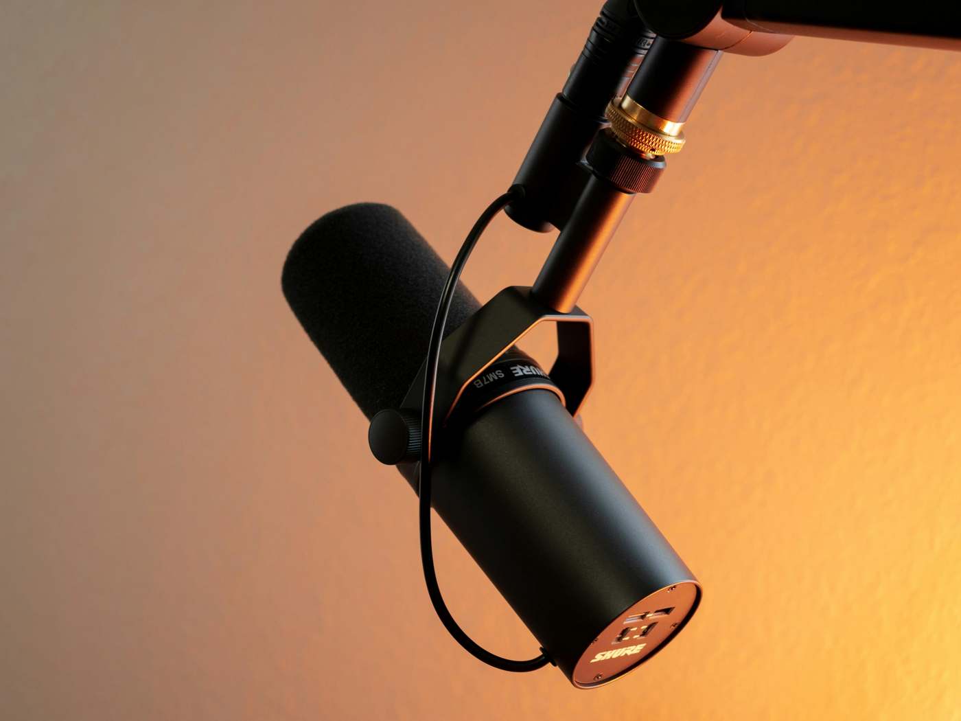 Dynamic microphone against a warm amber backdrop